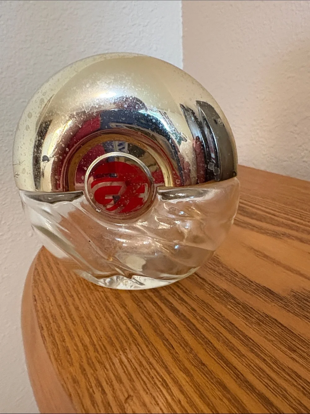 Avon Foxfire, empty, Round Silver-Tone Glass Decorative Bottle with Red Emblem